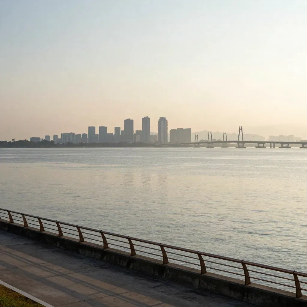 Pemandangan pagi Johor Bahru dengan skyline tepi laut dan jambatan berkabus
